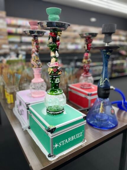 Colorful Starbuzz hookahs displayed on table inside One Stop Smoke Shop Houston
