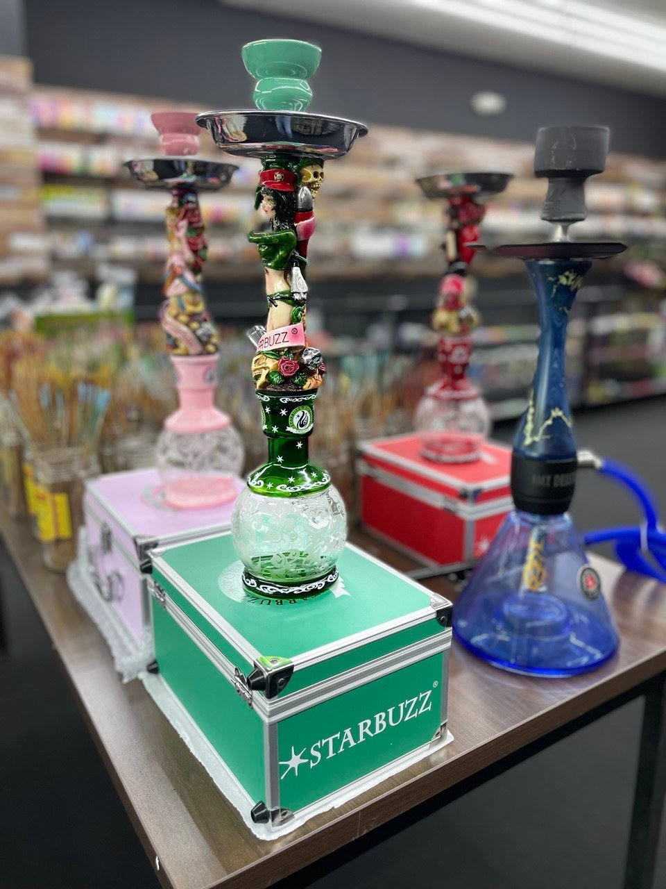 starbuzz hookah Colorful Starbuzz hookahs displayed on table inside One Stop Smoke Shop Houston